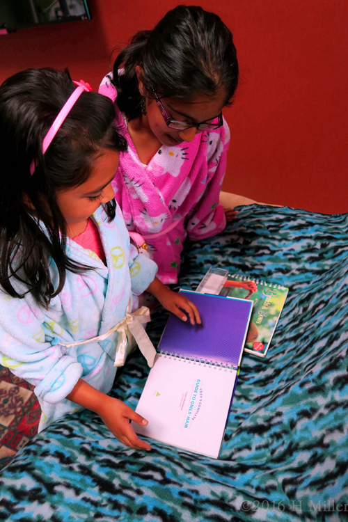 The Birthday Girl And Her Friend Checking Out The Hair Styling Books. The Birthday Girl And Her Friend Checking Out The Hair Styling Books.