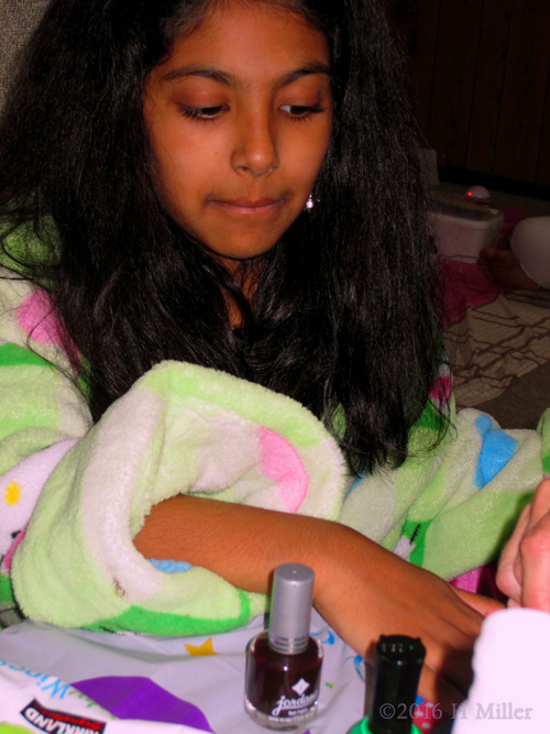 Using The Nail Dryer On Her Manicure.
