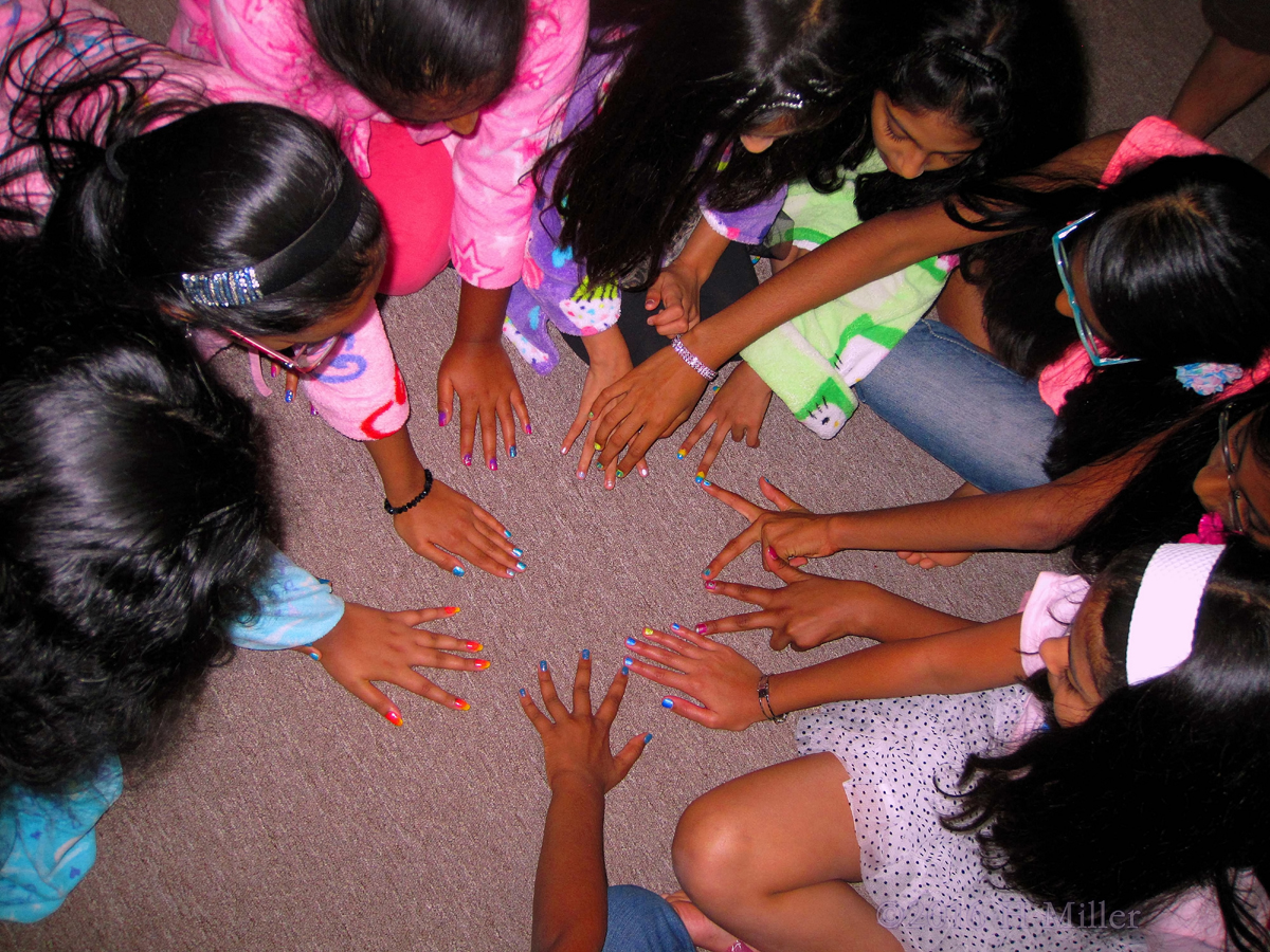 Sitting In A Circle Showing Their Kids Manis. 