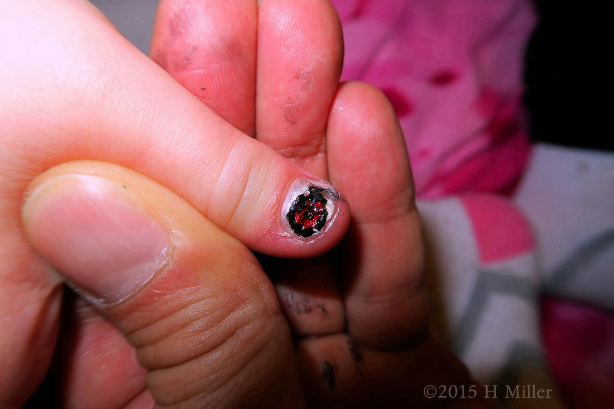 A Closeup Of The Ladybug Nail Art On Her Thumb 