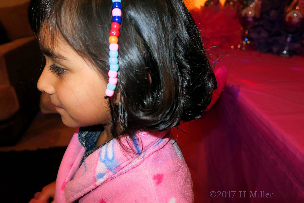 Close Up Of Her Beaded Hairstyle. 