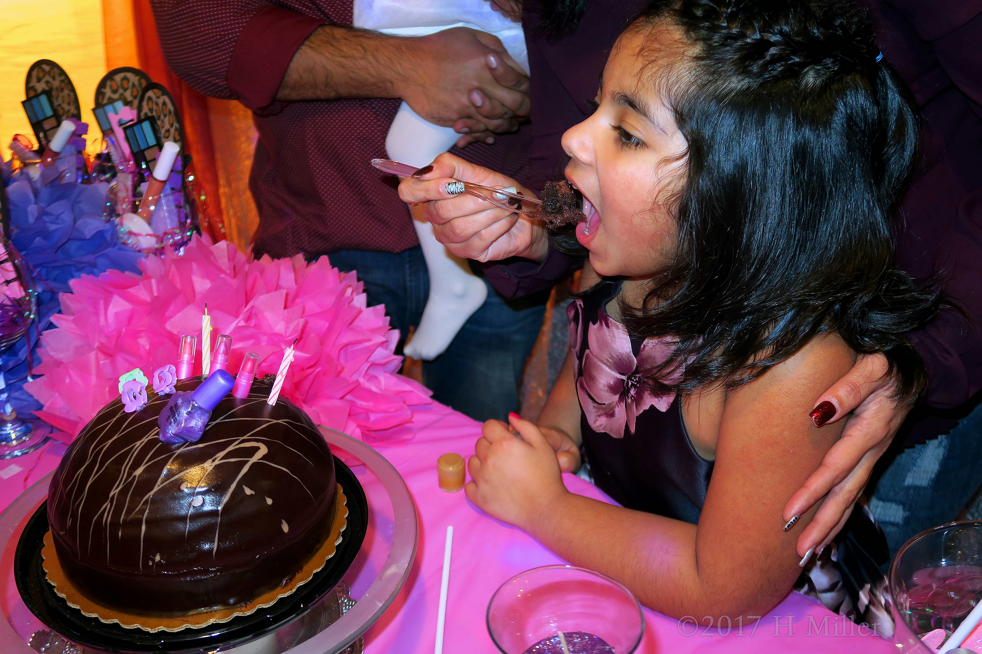 Her Mom Feeds Her The Birthday Cake. 