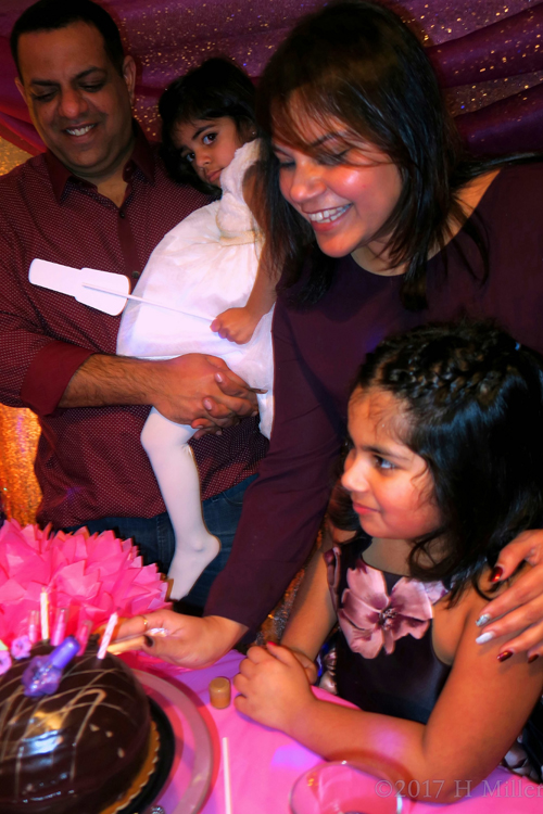 The Family Gathered Around The Birthday Cake.