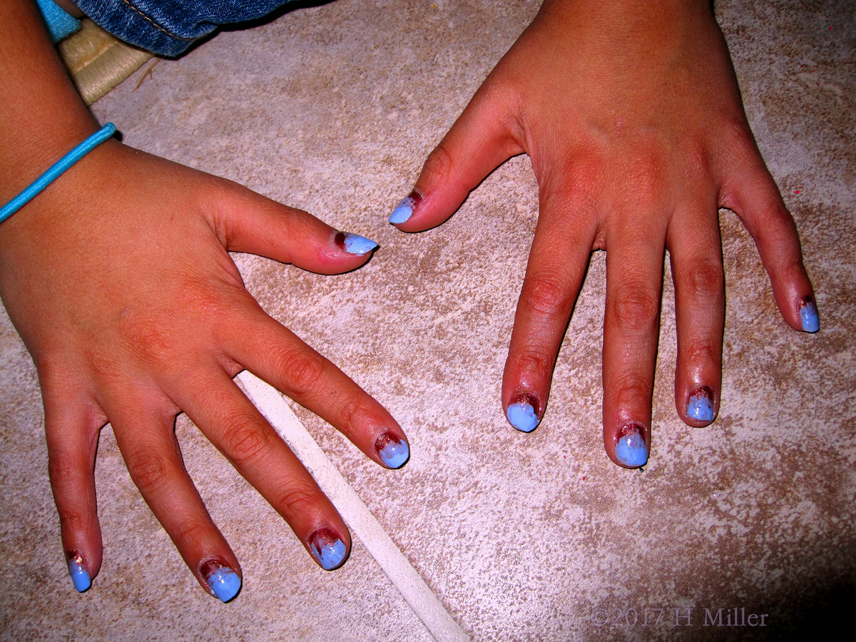Girls Manicure Closeup Of The Ombree. Very Pretty Blue And Red. 