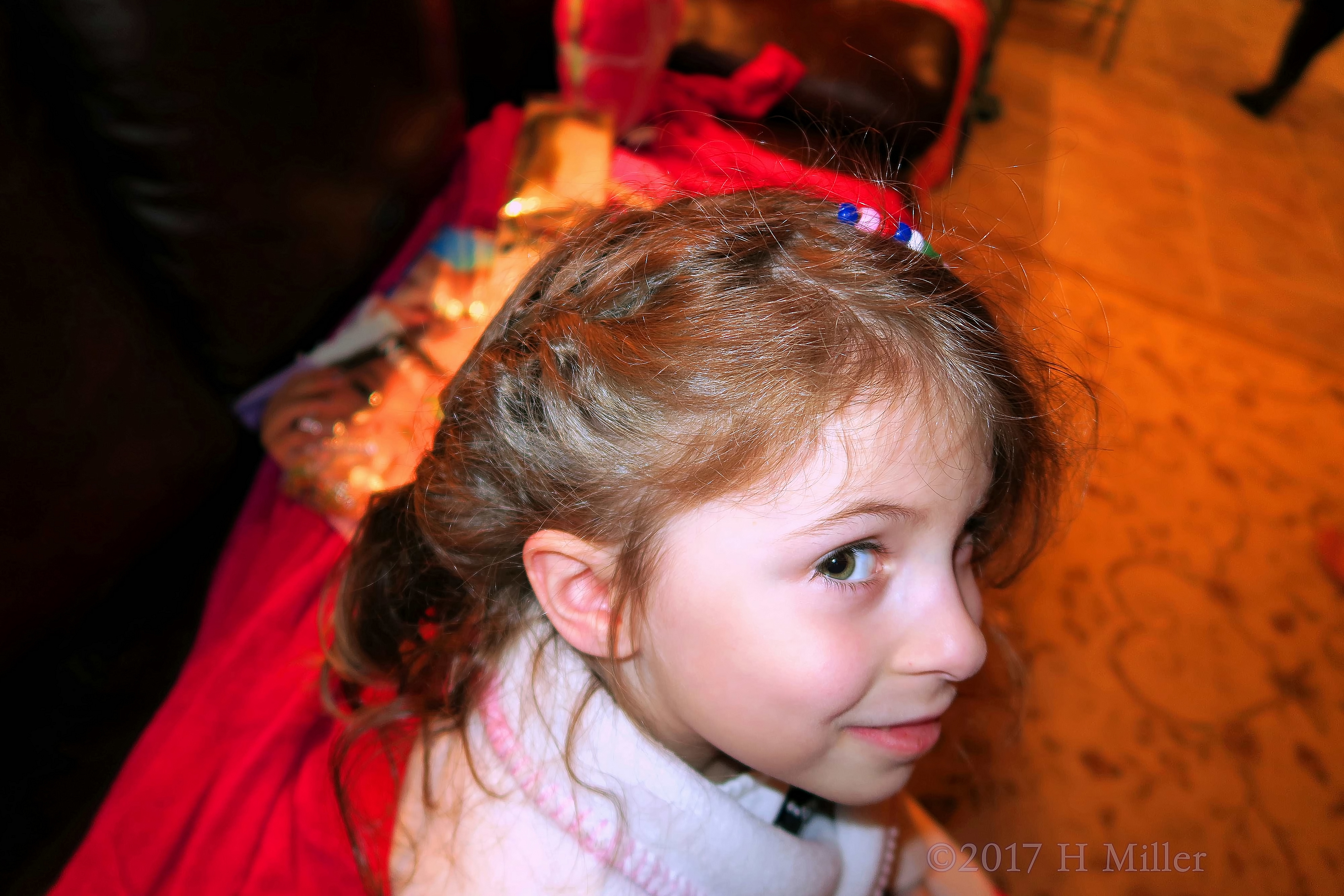 A Pretty Braid And Beads For Her Hairstyle. 