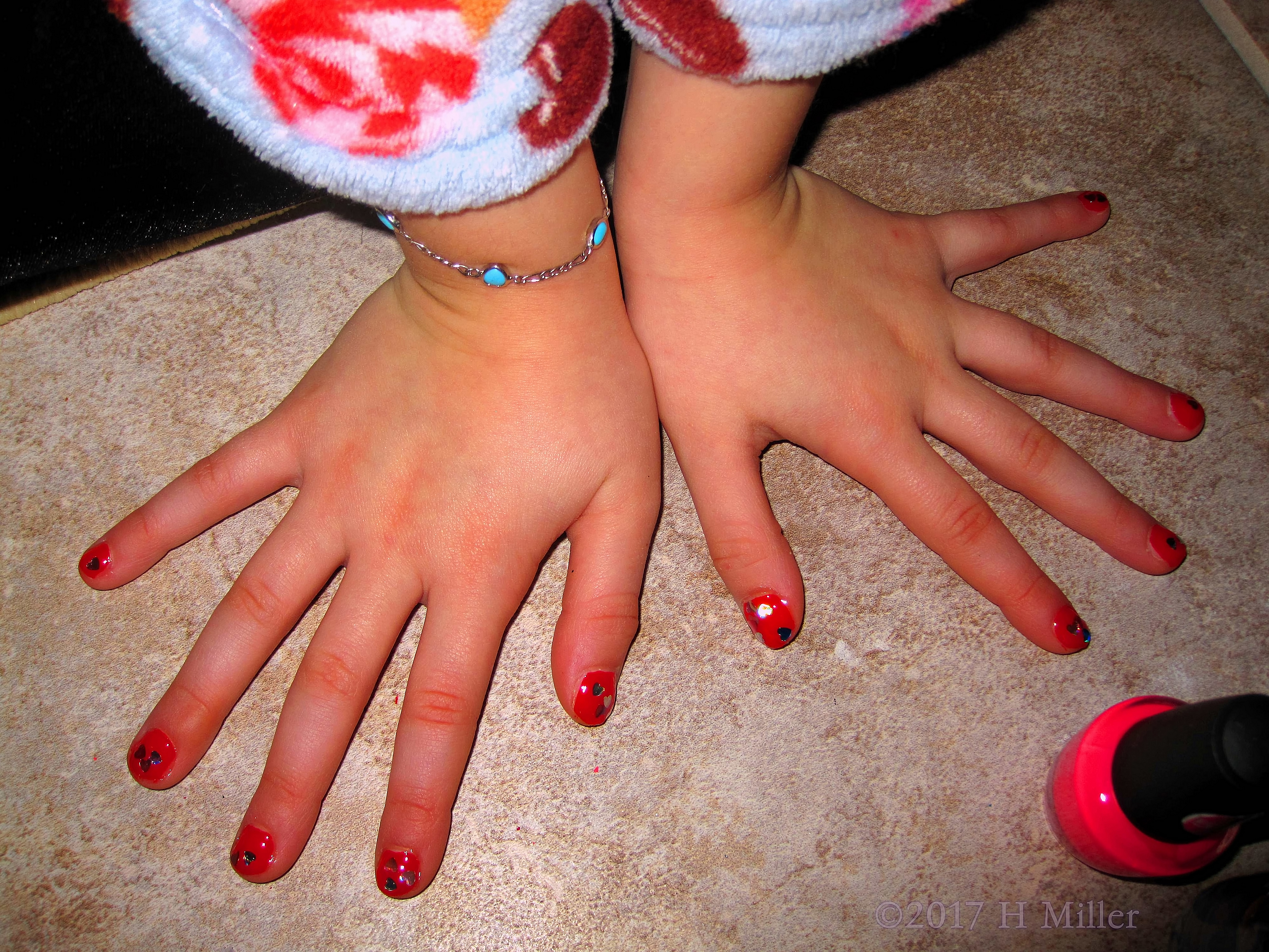 Red Nail Polish With Heart Glitter For This Girl's Mini Manicure. Red Nail Polish With Heart Glitter For This Girl's Mini Manicure.
