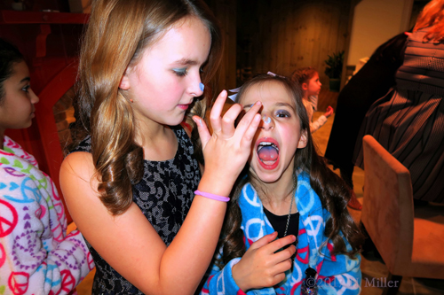 Putting Frosting On Alexa's Nose,Too At The Kids Spa!