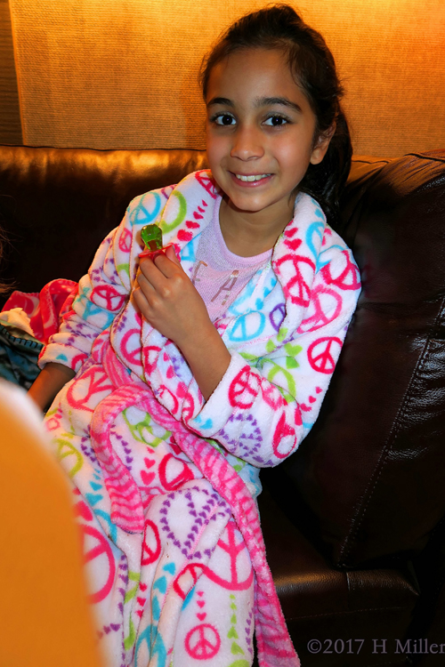 She Is Having Lots Of Fun At The Kids Party, With A Green Ring Pop. She Is Having Lots Of Fun At The Kids Party, With A Green Ring Pop.