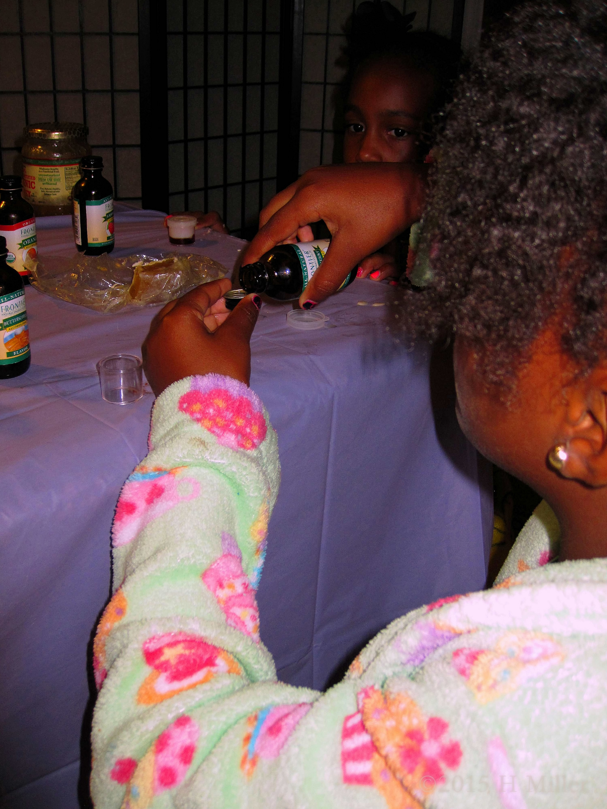 Carefully Pouring The Flavoring Out For The Lip Balm Carft.
