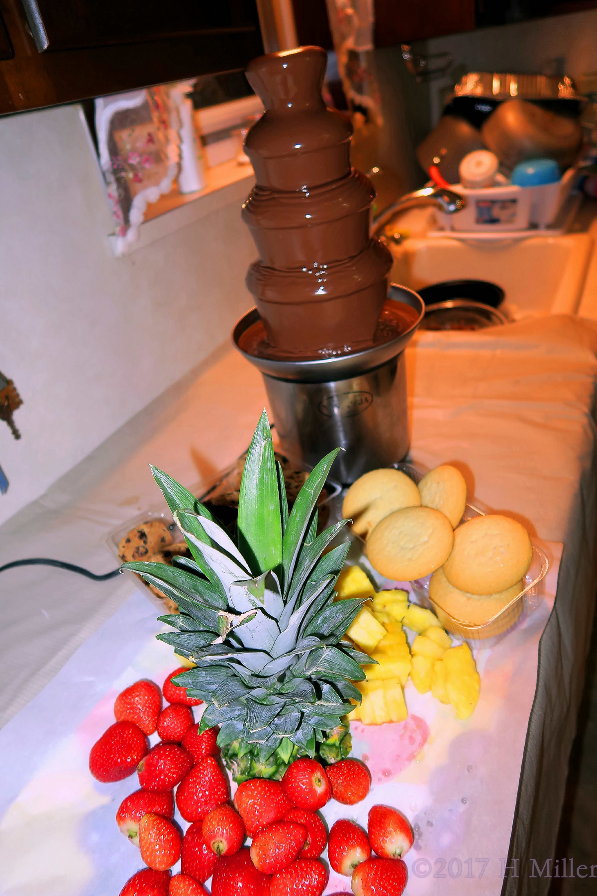 The Chocolate Fountain With Pineapples, Strawberries, And Cookies For Dipping! 