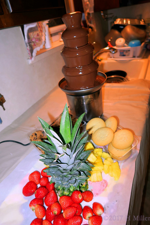 The Chocolate Fountain With Pineapples, Strawberries, And Cookies For Dipping!