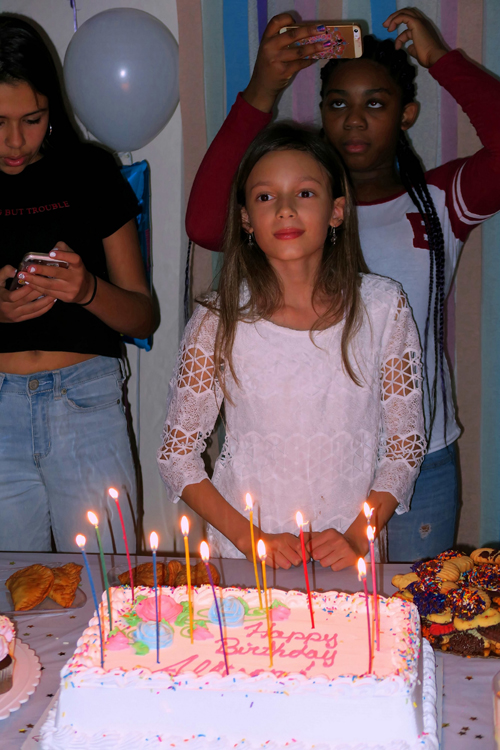 The Birthday Girl Smiles While Waiting For Cake.