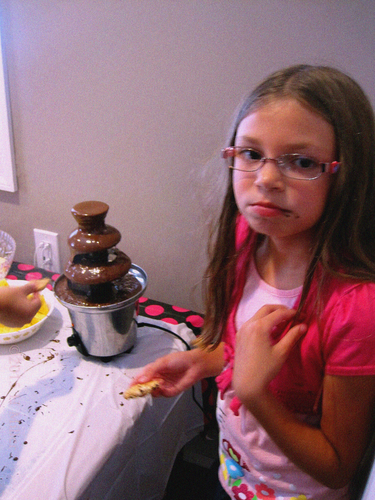 The Birthday Girl Eating Cookies Dipped In The Chocolate Fountain.