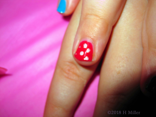 Close Shot Of The Beautiful Glitter Dots On This Girls Manicure.