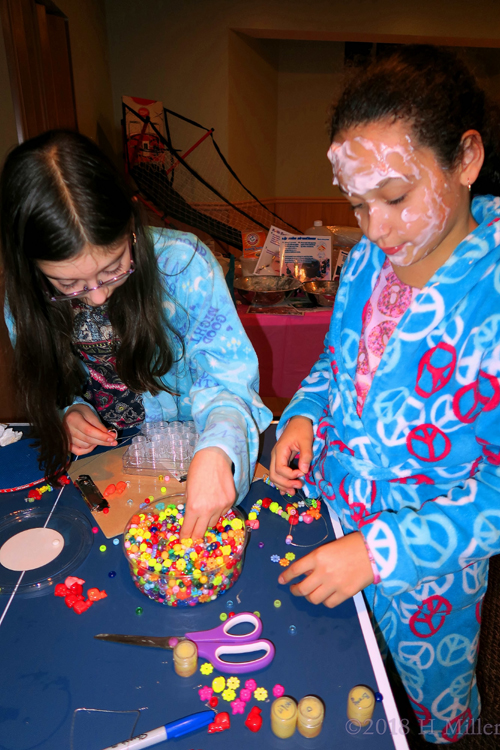 The Girls Are Putting Beads On A String To Make Some Cool Necklaces And Bracelets. The Girls Are Putting Beads On A String To Make Some Cool Necklaces And Bracelets.