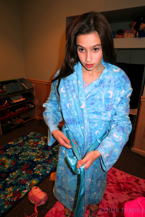 Tying The Knot Of Her Blue Spa Robe.