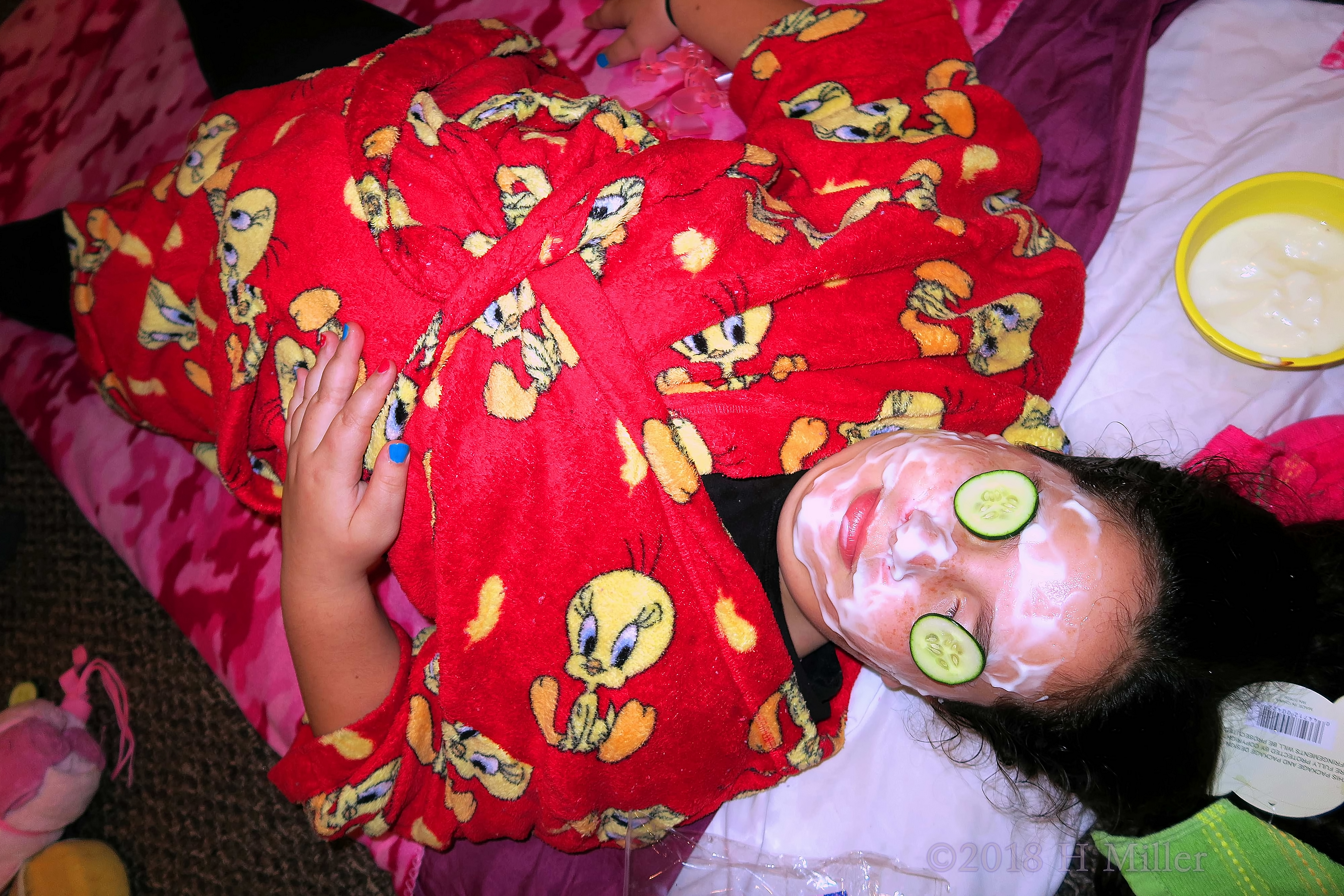 With The Masque And Slice Of Cukes, She Is Enjoying The Kids Facial!