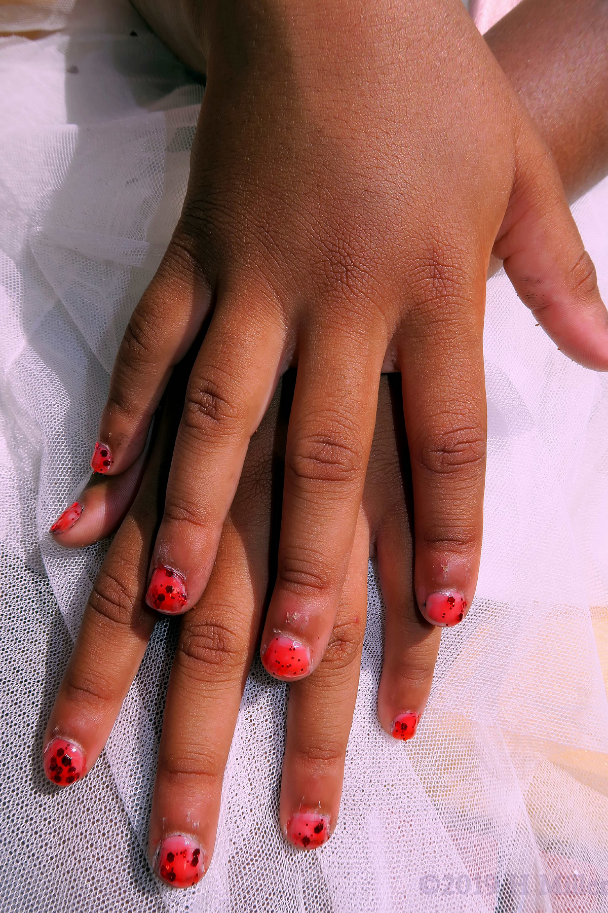 Vibrant Red Nail Coat With Dark Red Glitter For This Kids Manicure 