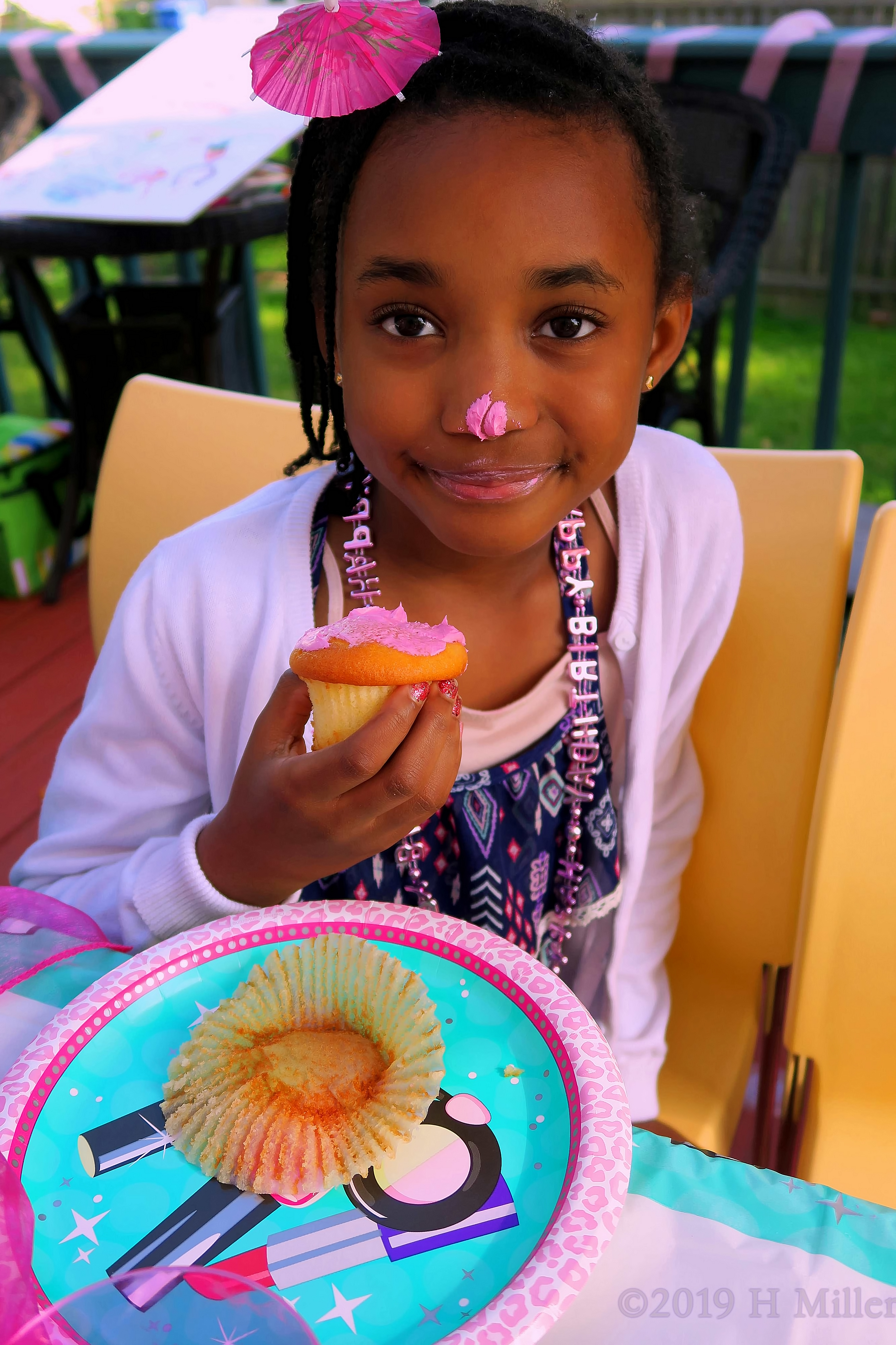 Party Guest Enjoying Her Birthday Cupcake 