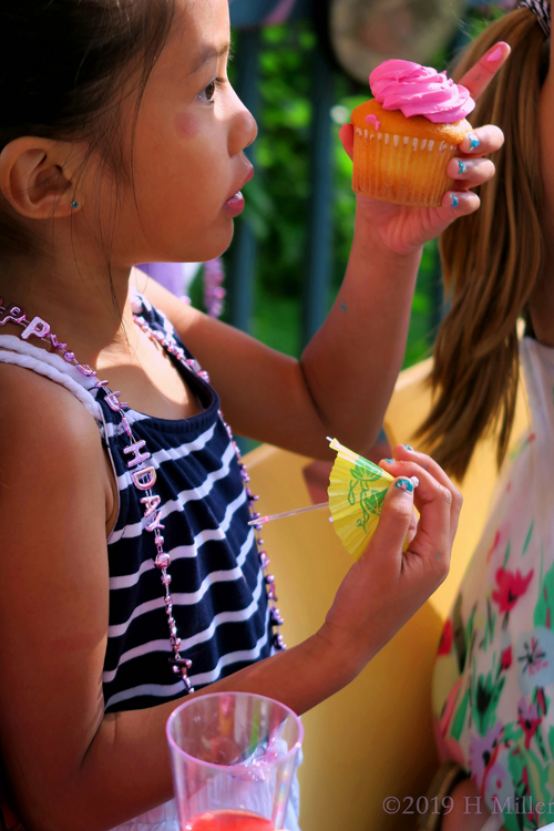 Party Guest About To Eat Her Cupcake Party Guest About To Eat Her Cupcake