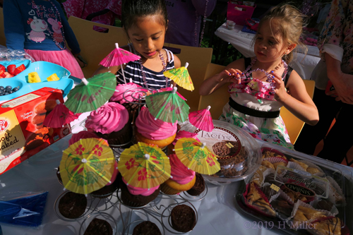 Party Guests Helping Themselves To Snacks From The Refreshments Station Party Guests Helping Themselves To Snacks From The Refreshments Station