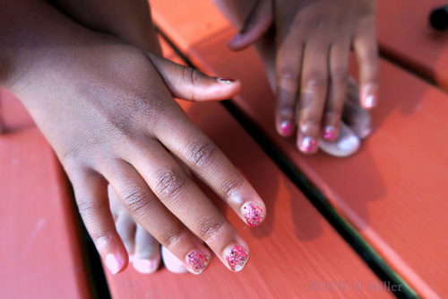 Red Tone Sparkles Over Pink On This Girls Manicure Red Tone Sparkles Over Pink On This Girls Manicure