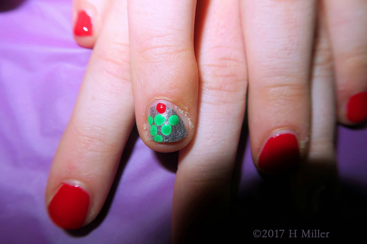 Lovely Red Kids Mini Manicure With Christmas Tree Nail Art On A Silver Nail 