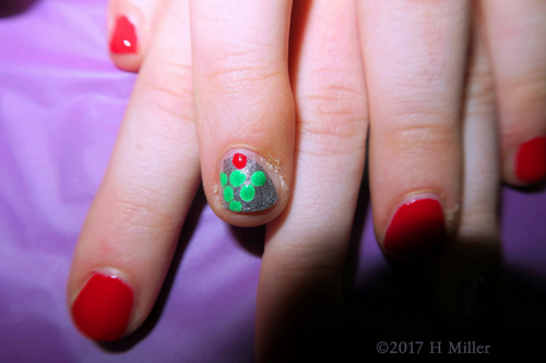 Lovely Red Kids Mini Manicure With Christmas Tree Nail Art On A Silver Nail