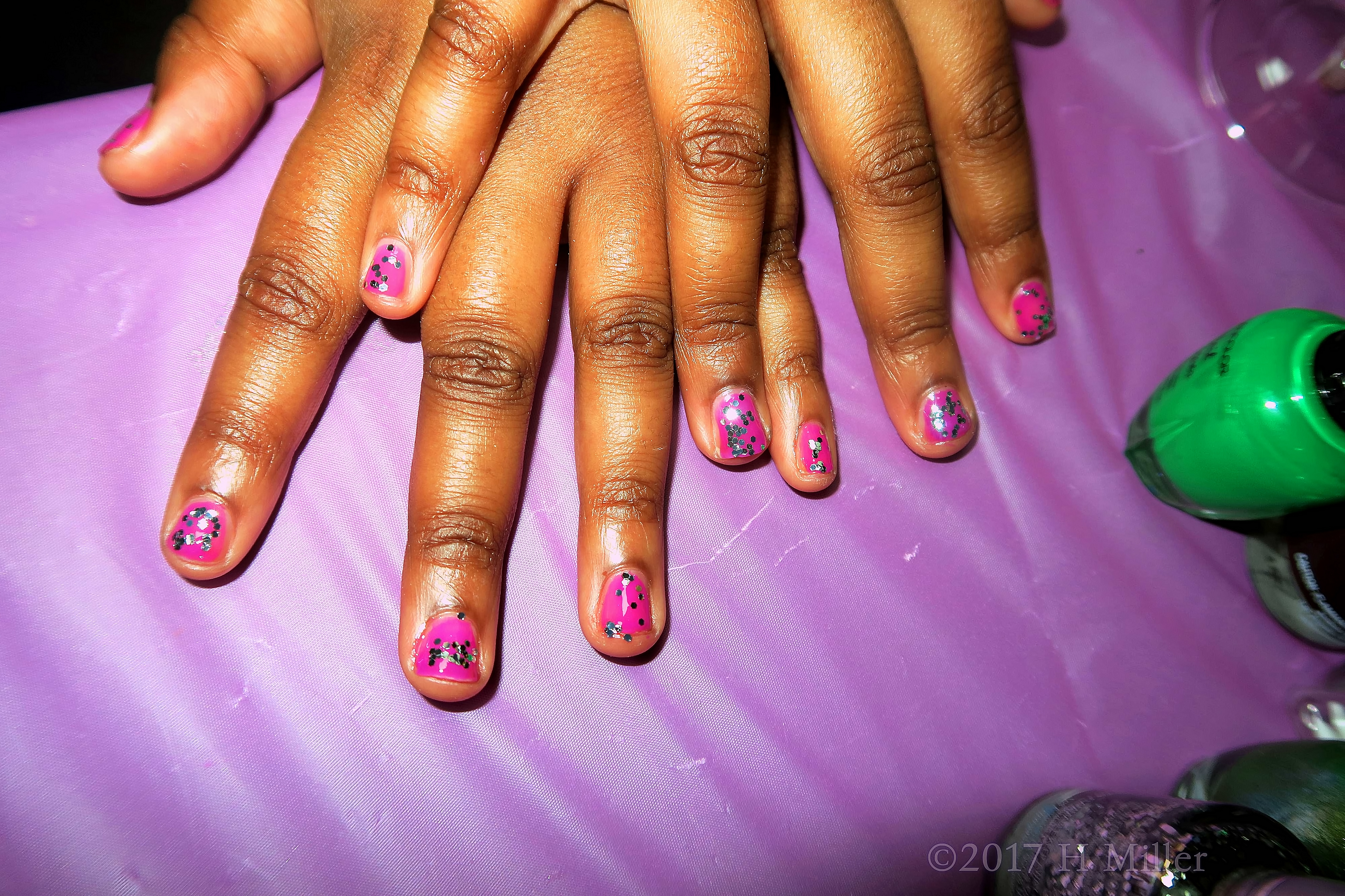 Beautiful Silvery Glitter Over Pink Nail Polish. 