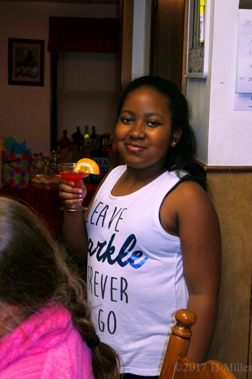 Birthday Girl Holds The Refreshment Cup For A Toast And Smiles.