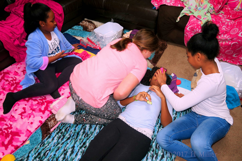 Girls Helping Their Friend, Enjoying The Kids Facial Treatment.
