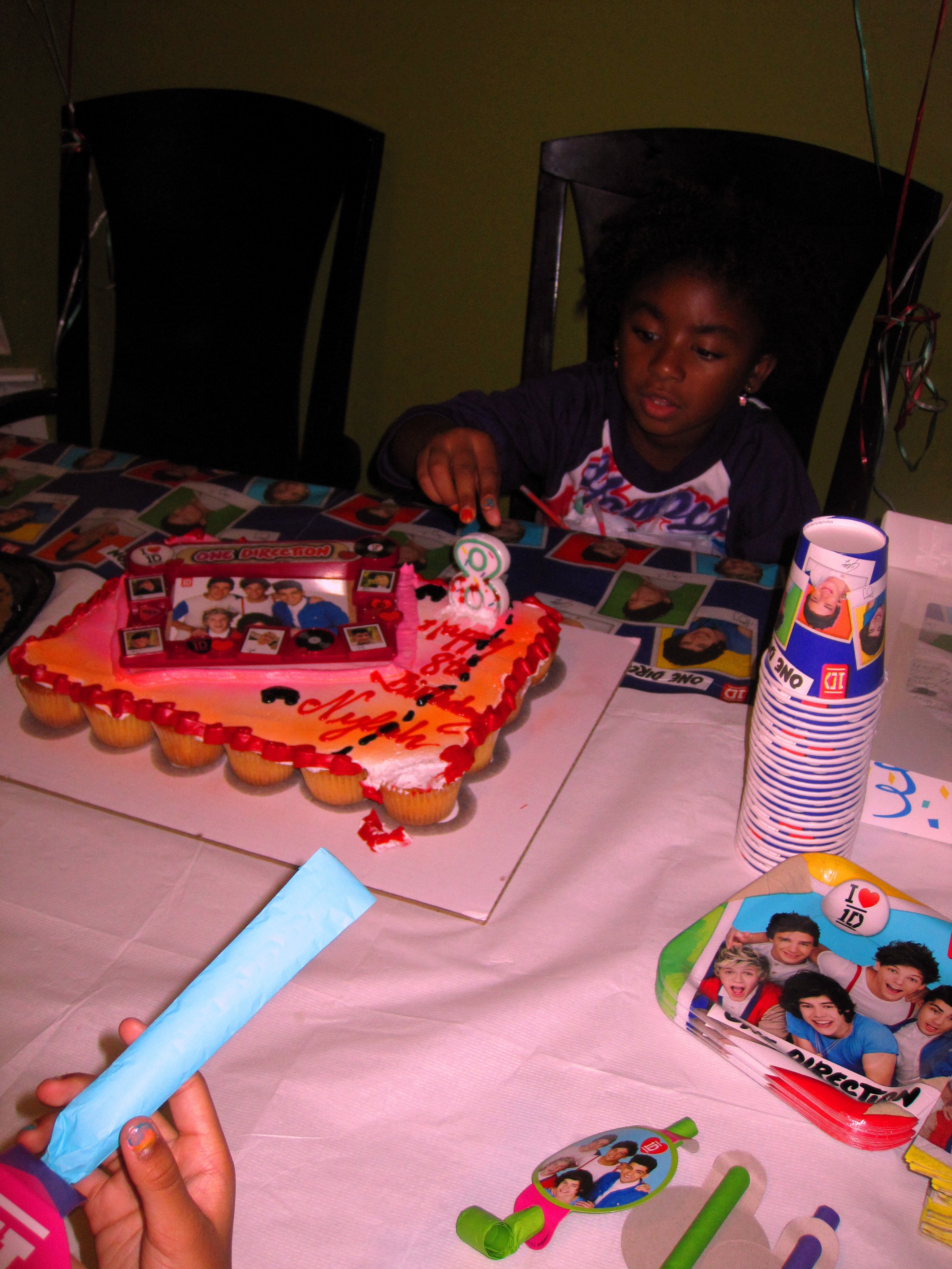 Examining The 8 Candle On Her Birthday Cake Examining The 8 Candle On Her Birthday Cake