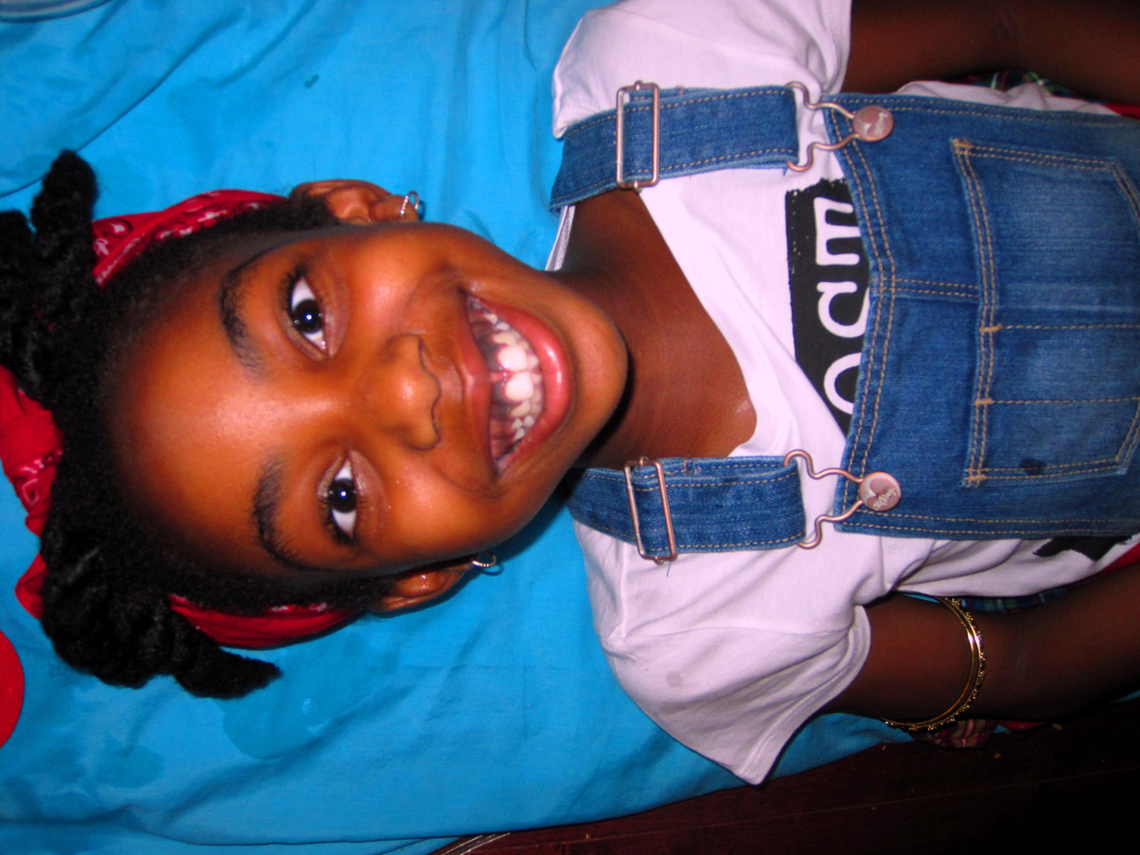 Happy Spa Kid On Blue Mat Waiting For Her Kids Facial To Begin Happy Spa Kid On Blue Mat Waiting For Her Kids Facial To Begin