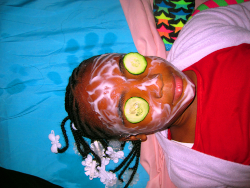 Cucumbers During Her Kids Facial With A White Spa Robe At The Spa Party