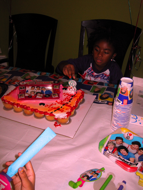 Examining The 8 Candle On Her Birthday Cake