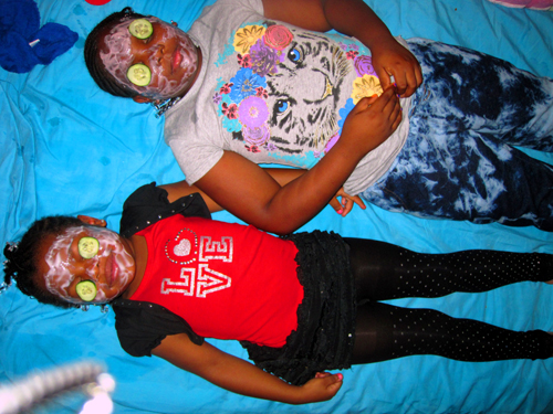 Two Spa Kids Getting Facials Together On The Blue Mat Two Spa Kids Getting Facials Together On The Blue Mat