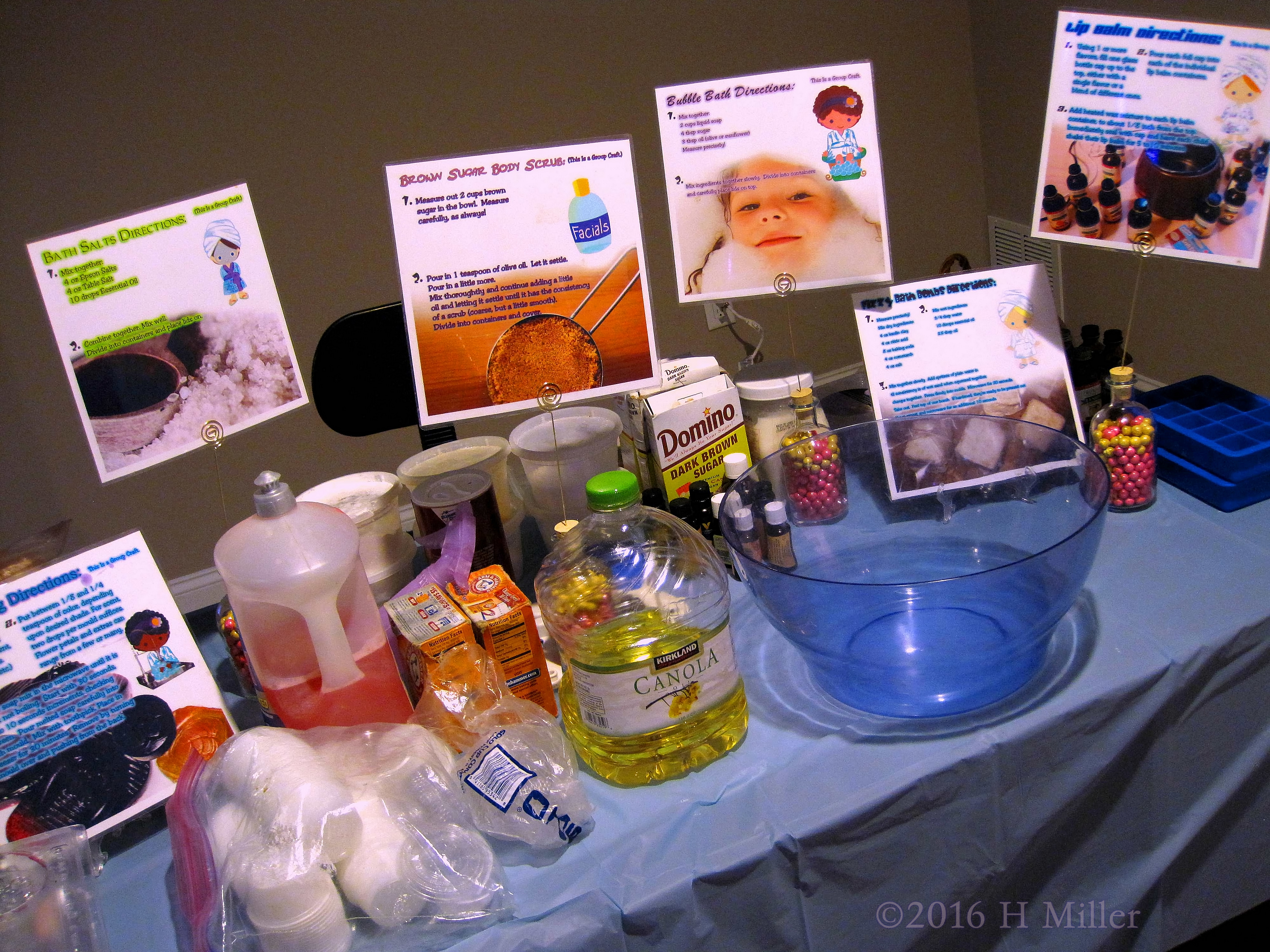 The Spa Craft Table With Ingedients And Utensils And Craft Cards.
