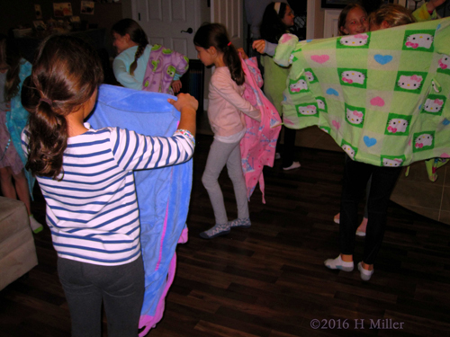 The Girls Putting On The Robes They've Selected.