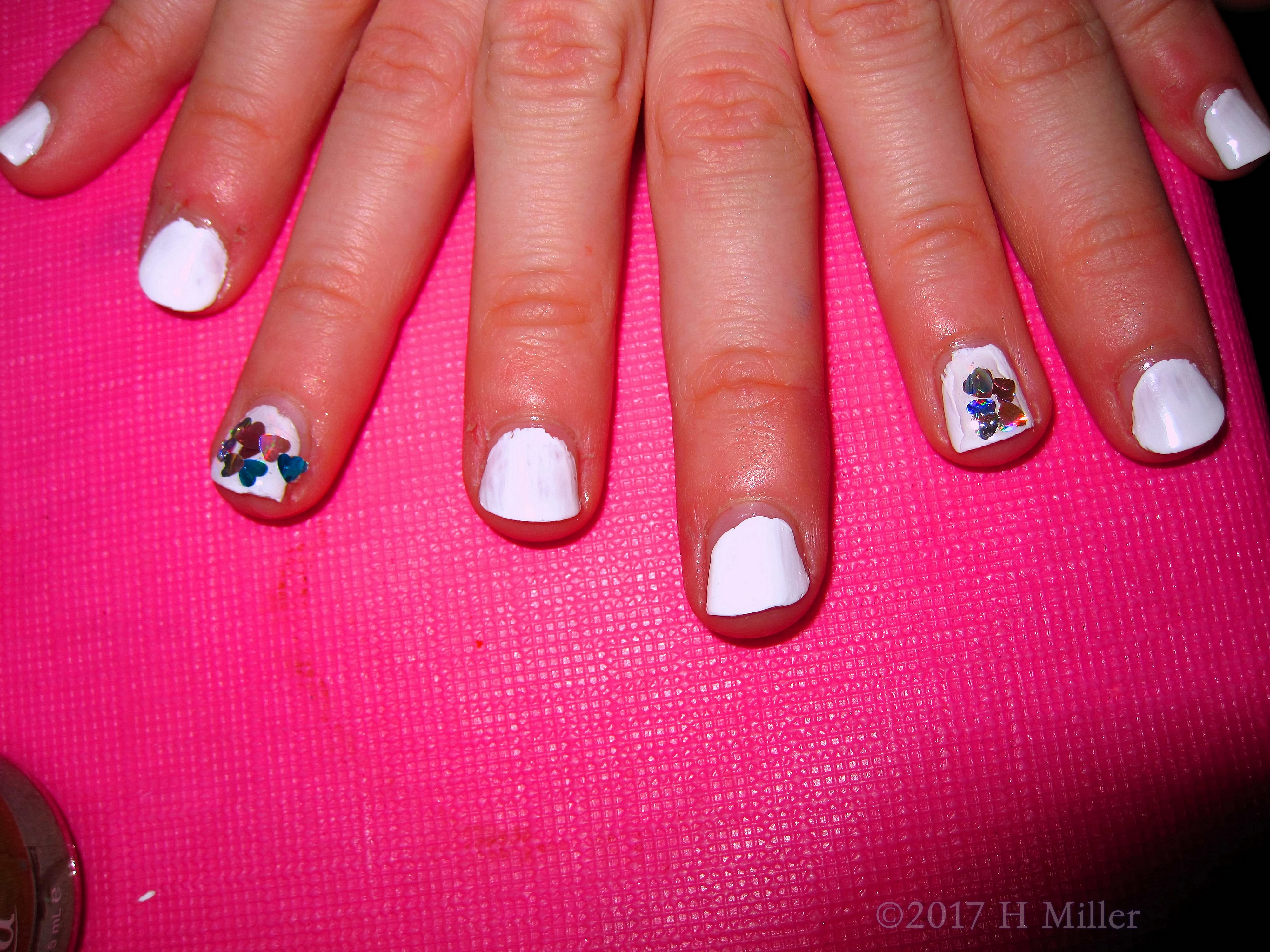 White Nail Polish With Sparkly Glitter Hearts. White Nail Polish With Sparkly Glitter Hearts.