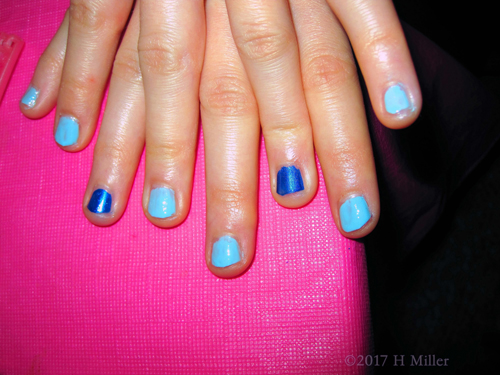 Closeup Of Her Dark Blue And Light Blue Kids Manicure. Closeup Of Her Dark Blue And Light Blue Kids Manicure.