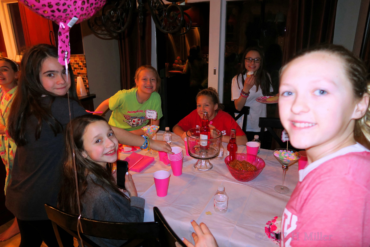 Smiling While Enjoying Snacks And Birthday Cake. 