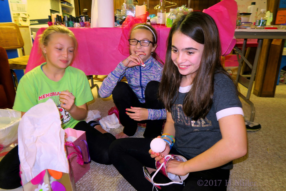 Smiling While Opening Her Present At The Kids Spa. 1
