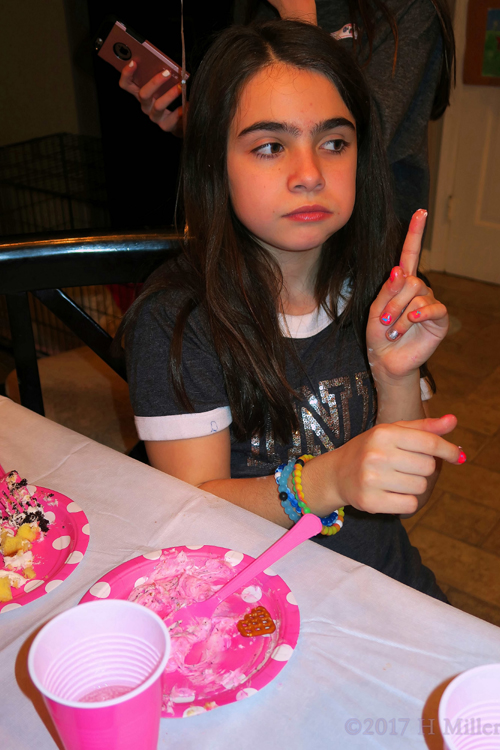 Audrey Is In Conversation At The Kids Party Cake Table.