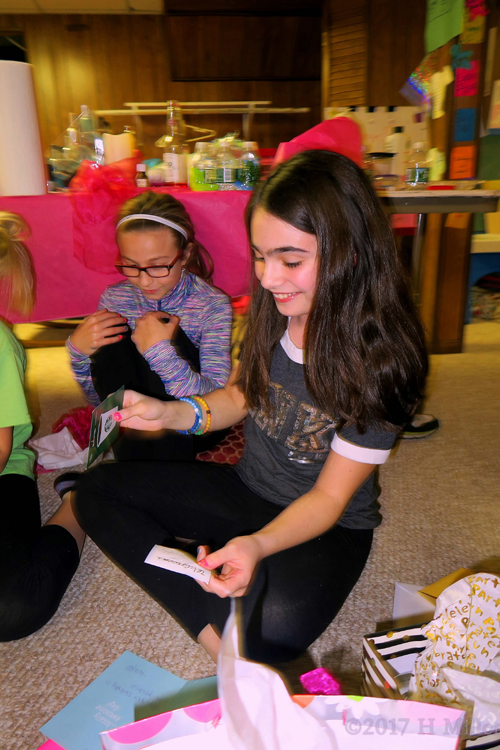 Reading The Card Received With Her Gift. 