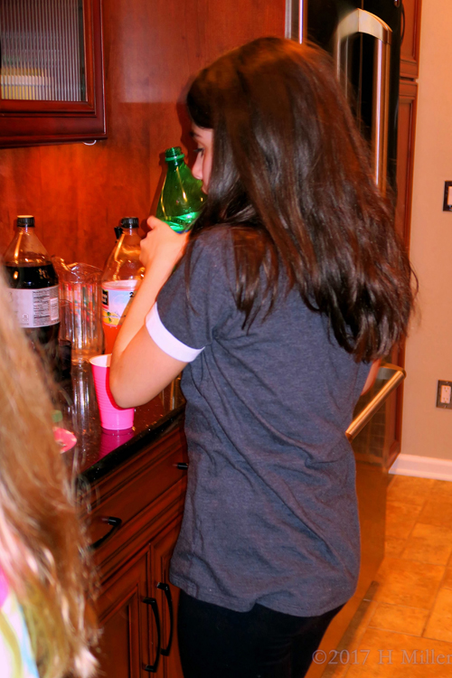The Birthday Girls Gets Some Soda During The Party.