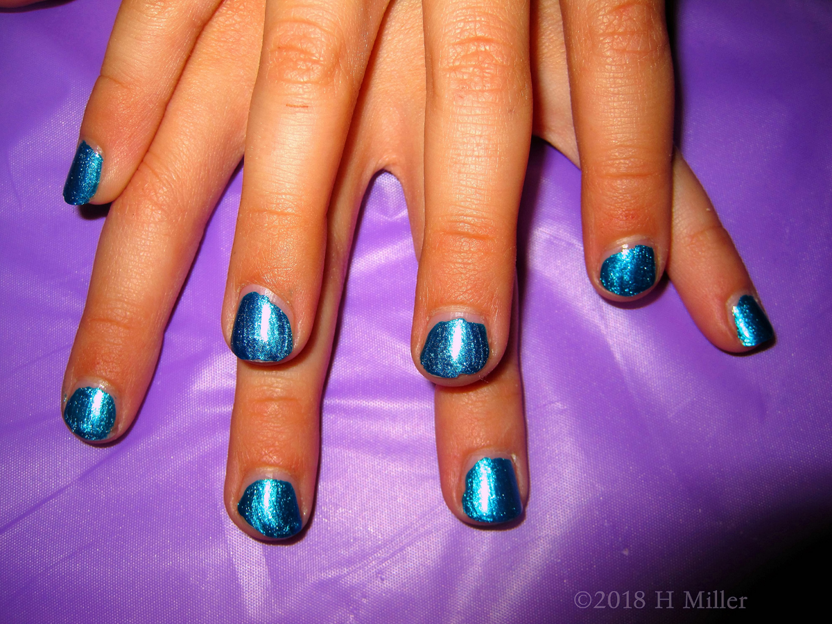 This Girls Manicure Is A Beautiful Shiny Blue.