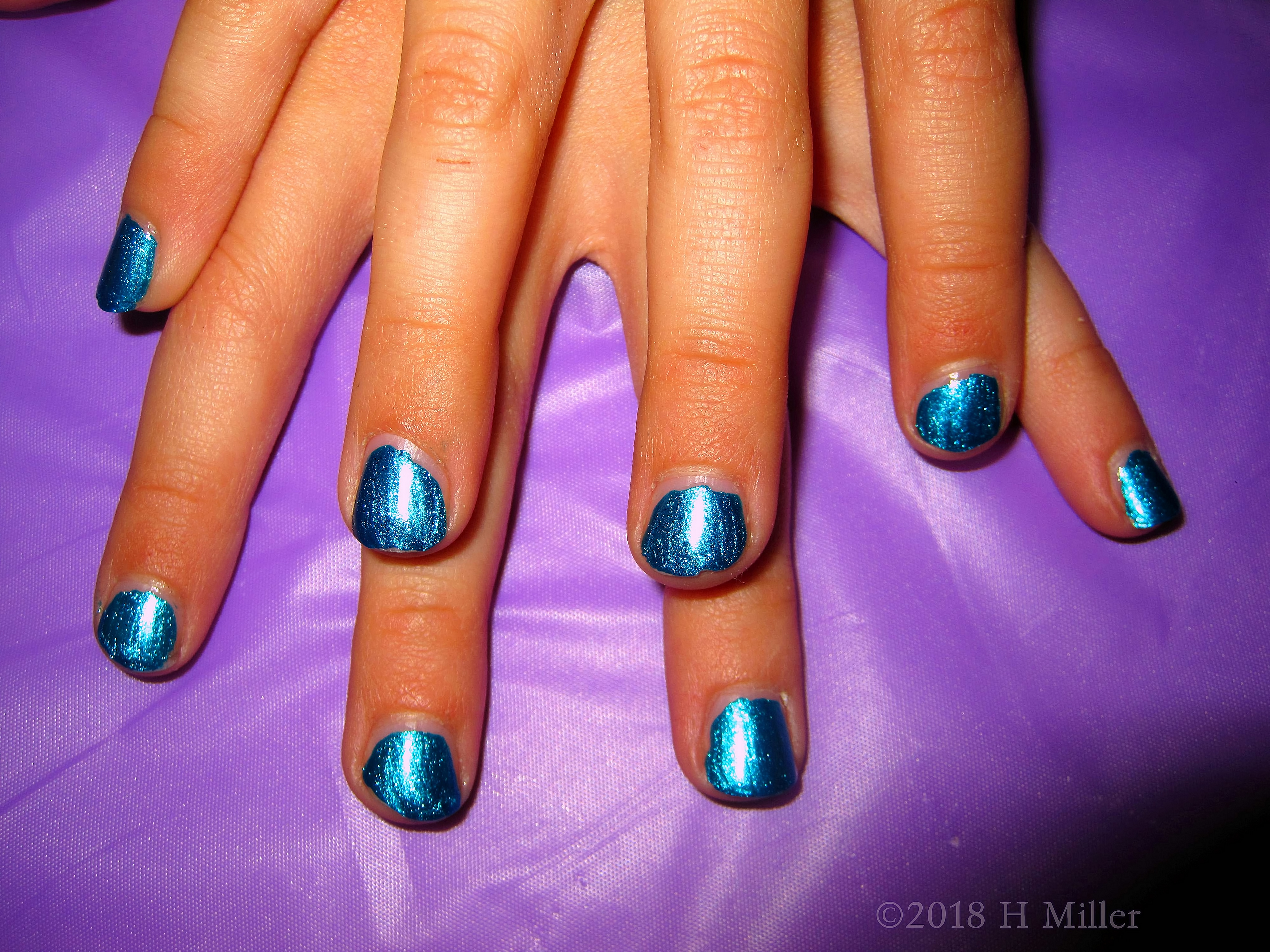 This Girls Manicure Is A Beautiful Shiny Blue. This Girls Manicure Is A Beautiful Shiny Blue.
