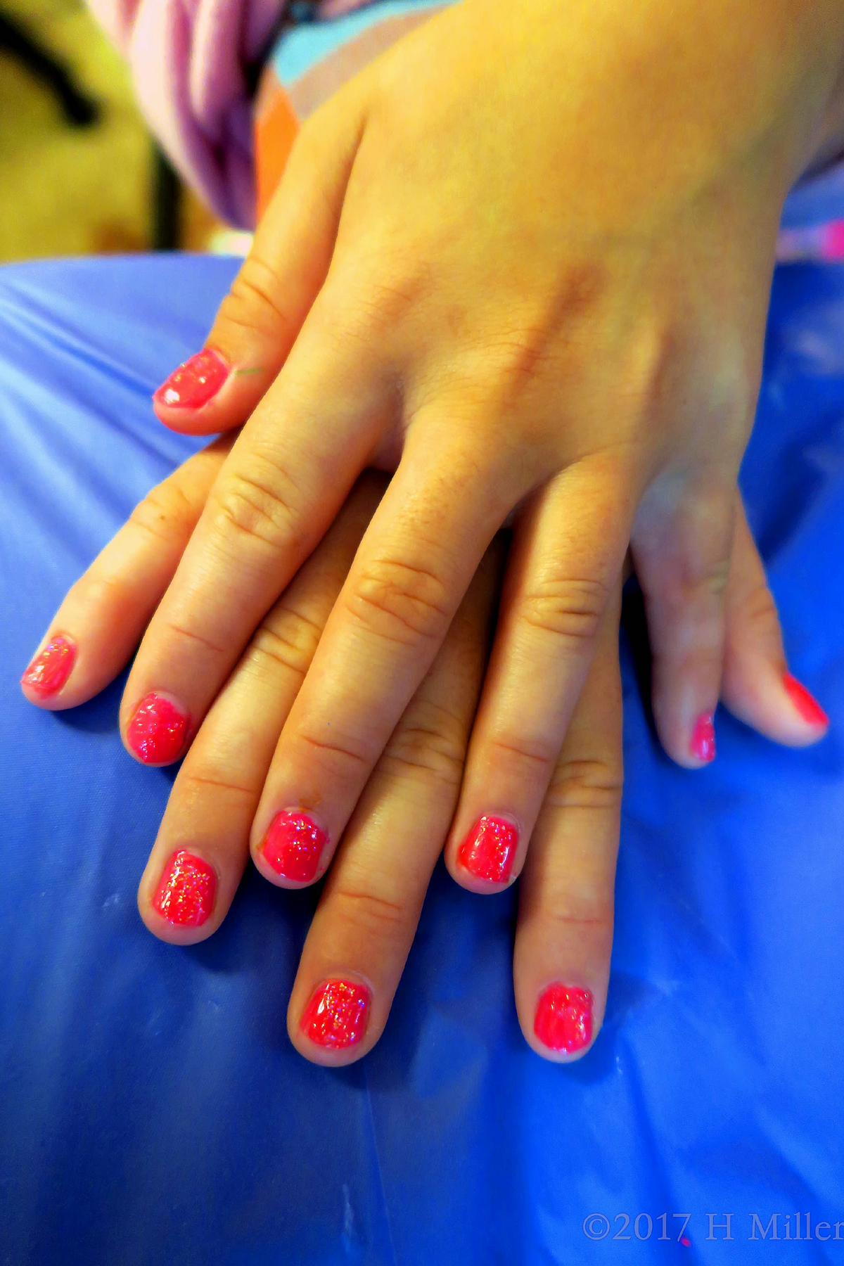 Bright Glossy Pink With A Touch Of Glitter For This Girls Mani! 