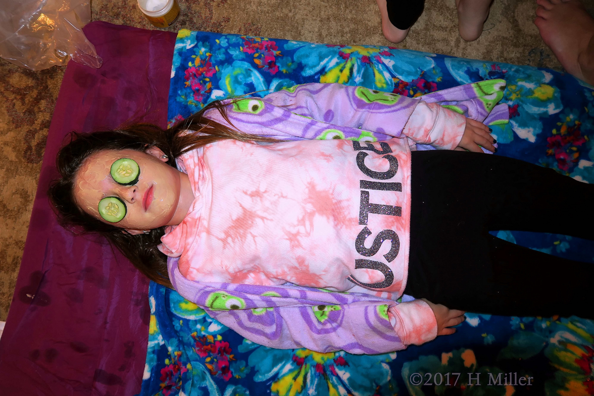 Lying Down For Her Kids Facial With Cukes On Her Eyes. 