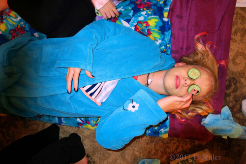 Applying Cucumbers To Soothe The Eyes During Girls Facials. Applying Cucumbers To Soothe The Eyes During Girls Facials.